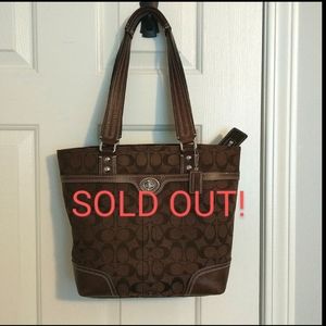 Coach signature canvas purse with leather trim and zip closure